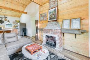 a living room with a brick fireplace and a couch at Abbeville Cabin on 450 Acres Near Lake Eufaula! in Abbeville