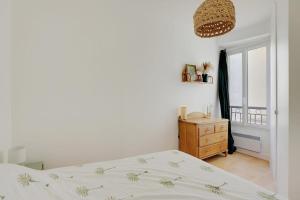 a bedroom with a bed and a dresser and a window at OBERKAMPF - BASTILLE Charming apartment in Paris