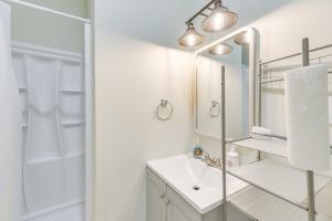 a white bathroom with a sink and a shower at Abbeville Cabin on 450 Acres Near Lake Eufaula! in Abbeville