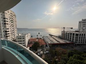 a view of the ocean from the balcony of a building at U-GO Refugio Tropical en El Laguito - Elegancia y Descanso in Cartagena de Indias