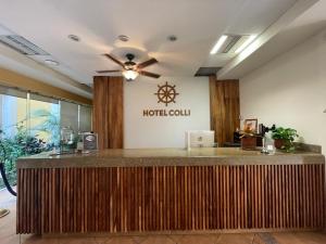 a hotel lobby with a hotel counter with a ceiling fan at HOTEL COLLI in San José del Cabo