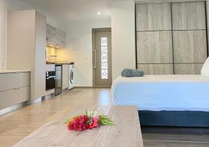 una camera da letto con un letto e un tavolo con dei fiori sopra di Mareta Lodge - studio TAHI 1 a Bora Bora