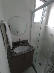 a bathroom with a sink and a mirror and a shower at Studio completo ao lado do metrô Brás in São Paulo