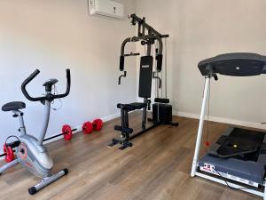 a gym with several exercise bikes and a treadmill at Depto cálido y moderno in San Nicolás de los Arroyos