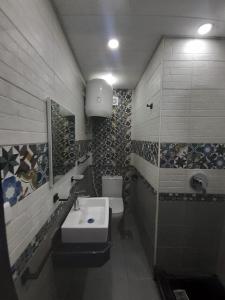 a bathroom with a sink and a toilet at بورتو مارينا الساحل الشمالي in El Alamein