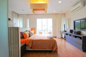 a bedroom with a bed and a large window at A Spacious & Lux 4BR House with Gazebo in Cheras
