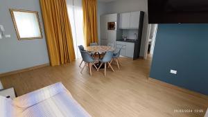 a room with a table and chairs and a kitchen at Residenza delle Nazioni in Gatteo a Mare +216 photos