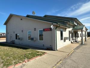 a white building with a sign that says open at AINSWORTHINN in Ainsworth
