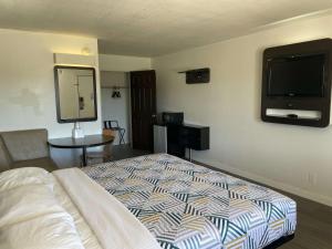 a bedroom with a bed and a flat screen tv at Motel 6-Wichita Falls, TX - North in Wichita Falls