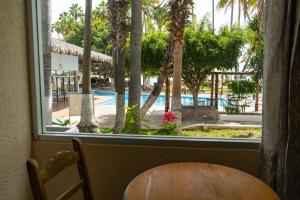 a window with a table and a view of a pool at La Concha Beach Hotel & Club in La Paz