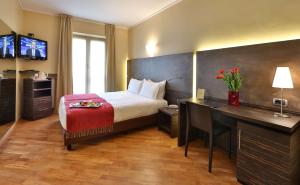 a hotel room with a bed and a desk with a computer at Best Western Hotel Metropoli in Genoa +65 photos