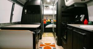 an rv kitchen with a sink and a bed at Egyptian Motor Hotel BW Signature Collection in Phoenix