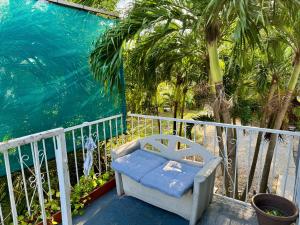 a chair sitting on a balcony next to the water at Miami Bright townhouse 3 bedroom free Parkig Garden in Miami