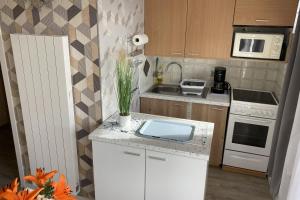 a kitchen with a white counter top and a sink at Apartment near the beaches of Villers-sur-Mer in Villers-sur-Mer