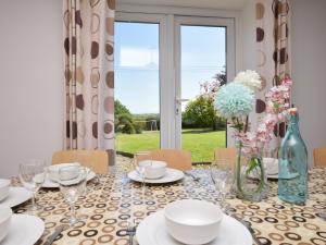 a dining room with a table with chairs and a window at 5 bed in Barnstaple SHIRW in Shirwell