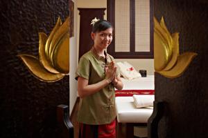 a young boy standing in a room with a bunch of bananas at Ausonia Hungaria Wellness & Lifestyle in Venice-Lido