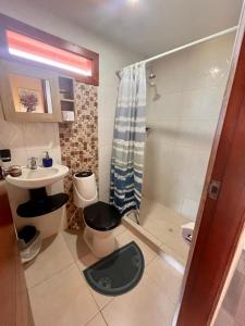 ein Bad mit einer Dusche, einem WC und einem Waschbecken in der Unterkunft Juanchos House Hostel Tayrona in Los Naranjos