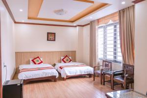 ein Hotelzimmer mit 2 Betten und einem Fenster in der Unterkunft Huong Duong Hotel Lao Cai in Lào Cai