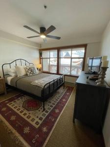 a bedroom with a bed and a ceiling fan at Ski In-Out Hot Tub Gym Sauna Pool Reserved Parking -501 in Brighton