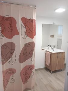 a bathroom with a shower curtain with a sink at EL RINCON DEL ROMERAL in Pegalajar +16 photos