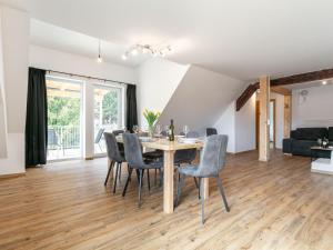 a dining room and living room with a table and chairs at NRV Top 5 in Möderbrugg