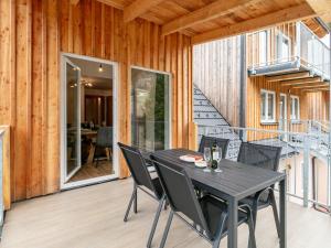 a patio with a black table and chairs at NRV Top 567 XL in Möderbrugg