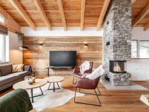 a living room with a stone fireplace at Grebenzen Lodge 35 in Sankt Lambrecht