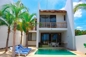 a villa with a swimming pool and palm trees at Patmos ocean view 3 bedroom house in San Benito