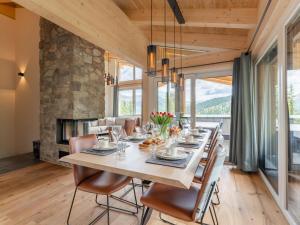 a dining room with a table and chairs and a fireplace at Vista Lodge in Turracher Hohe