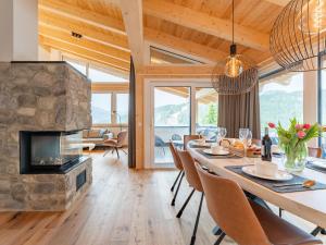 a dining room with a table and a fireplace at Ibex panorama Lodge in Turracher Hohe