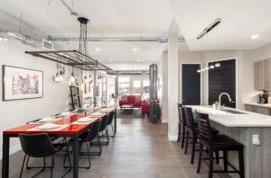 a kitchen and dining room with a red table and chairs at Denver suites rino arts loft - jz vacation rentals in Denver