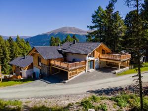 an image of a home with a mountain in the background at The Cosy Bear Lodge in Turracher Hohe
