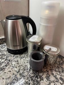 a kitchen counter with a coffee pot and a tea kettle at Lautaro in San Juan