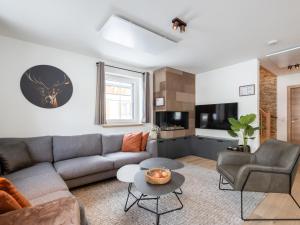 a living room with a couch and a table at Edelweiss Lodge in Donnersbachwald