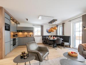 a living room and kitchen with a table and chairs at Edelweiss Lodge in Donnersbachwald