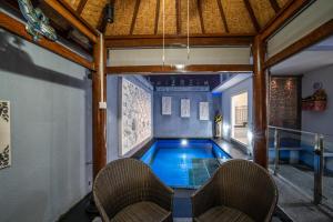 a swimming pool in the middle of a house at Modern villa with private pool , full kitchen and parking in Legian
