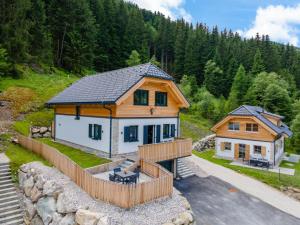 a large wooden house with a fence in front of it at Edelweiss Lodge in Donnersbachwald