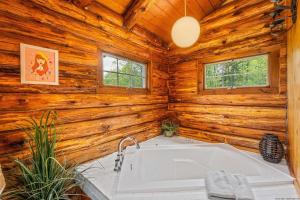 uma casa de banho com banheira e paredes de madeira em Woodchuck Sanctuary em Roxbury