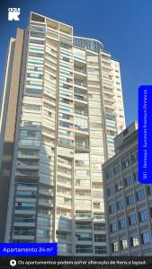 a large office building with a blue sign in front of it at 1811 - Rentaqui Summint Premium Pinheiros in Sao Paulo