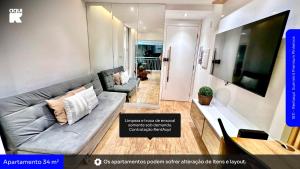 a living room with a couch and a tv at 1811 - Rentaqui Summint Premium Pinheiros in Sao Paulo