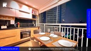 a kitchen with a table and chairs and a balcony at 1811 - Rentaqui Summint Premium Pinheiros in Sao Paulo