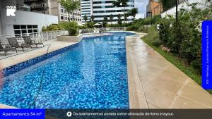 a large blue swimming pool in a building at 1811 - Rentaqui Summint Premium Pinheiros in Sao Paulo