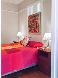 a bedroom with a bed with a laptop on it at West End Luxury 4B3B Home w Parking and Home Pod Music System M9 in Brisbane