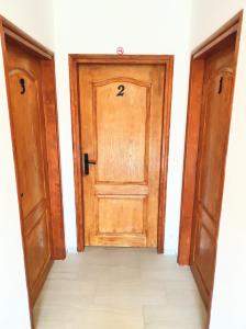 two doors with the number on them in a room at Golubina 2 - Studio Apartman in Golubac