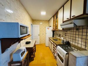 Η κουζίνα ή μικρή κουζίνα στο Apartamento na General Osório