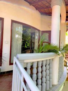 a balcony of a house with a white railing at Jungle Addition in Phnom Penh