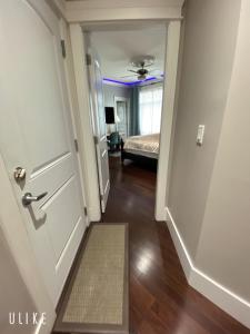 a hallway with a door leading to a bedroom at Comfortable suite for guests to use independently in Burnaby