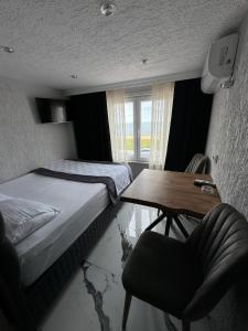 1 dormitorio con 1 cama, 1 mesa y 1 silla en İdeal Butik Otel, en Arnavutköy