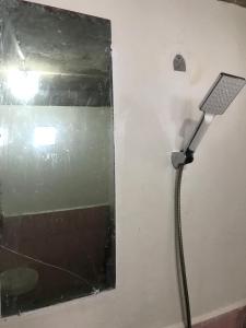 un tubo collegato a un muro con uno specchio di ORA KOMODO HOME STAY a Komodo
