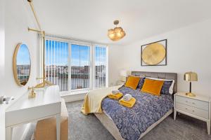 a bedroom with a bed with yellow pillows at Mearns Street Suite ✪ Grampian Lettings Ltd in Aberdeen